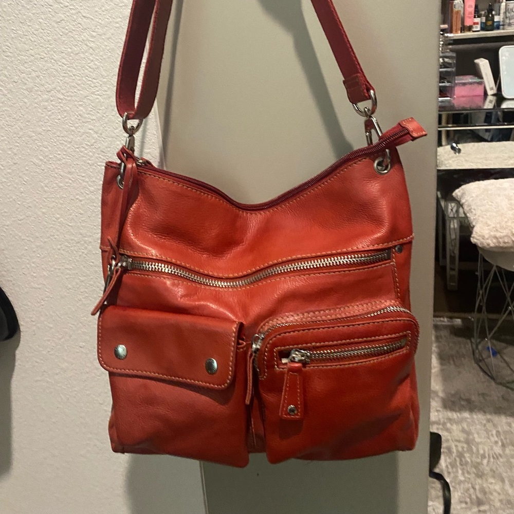 Burnt red fossil leather purse.